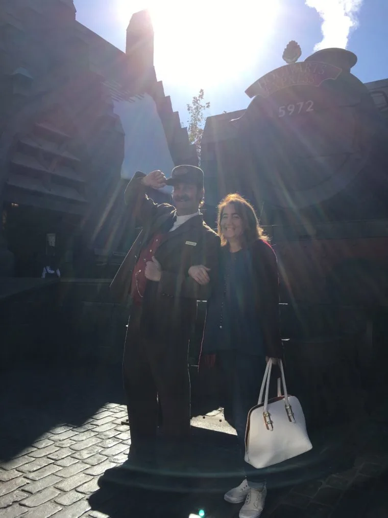 Sarah with conductor of the Hogwarts express at Wizarding World of Harry Potter