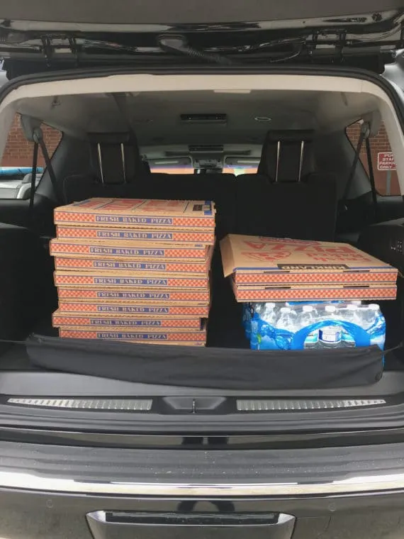 stack of pizza boxes in the back of GMC Yukon XL Denali 