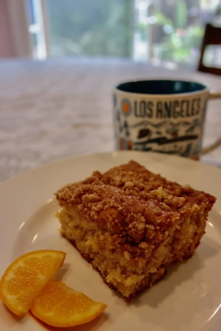 lausd coffee cake slice on a plate with coffee and orange slices