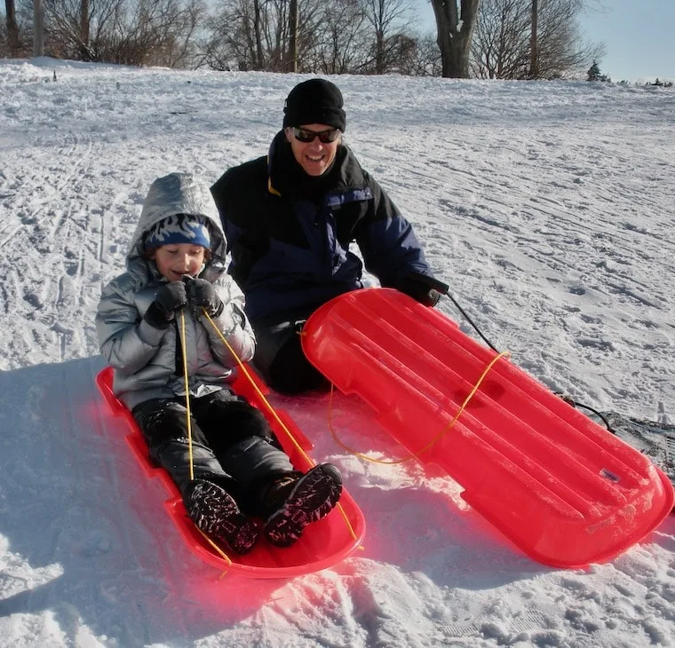 dad and kid ready to sled