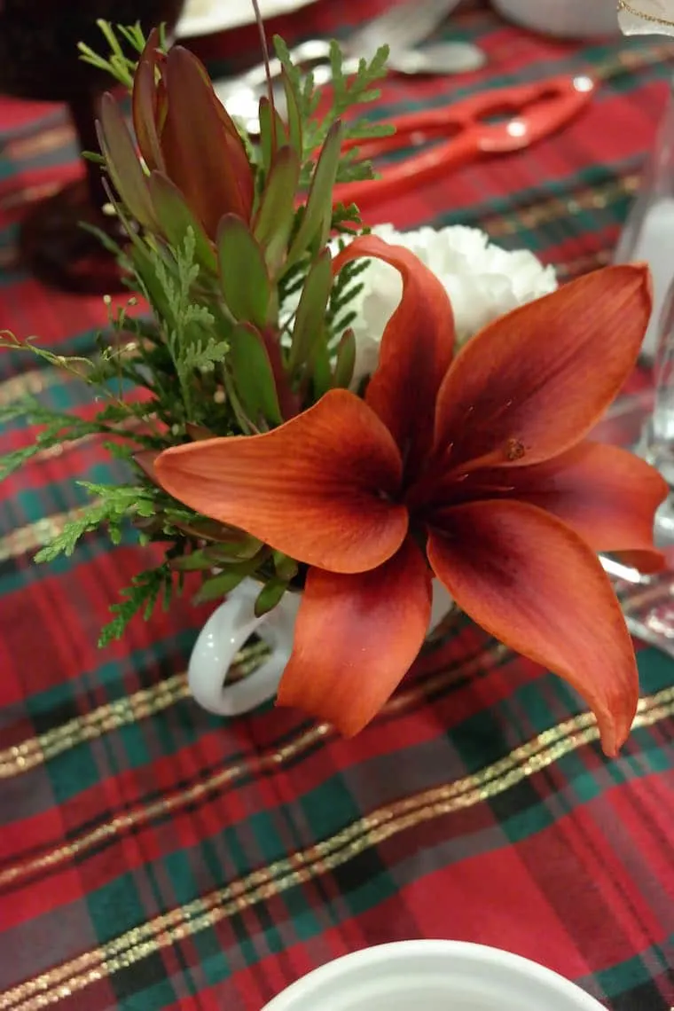 Christmas dinner table set with a lily
