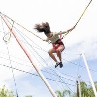 Girl-on-bungee-jumping-with-joy-at-Summer-Camp