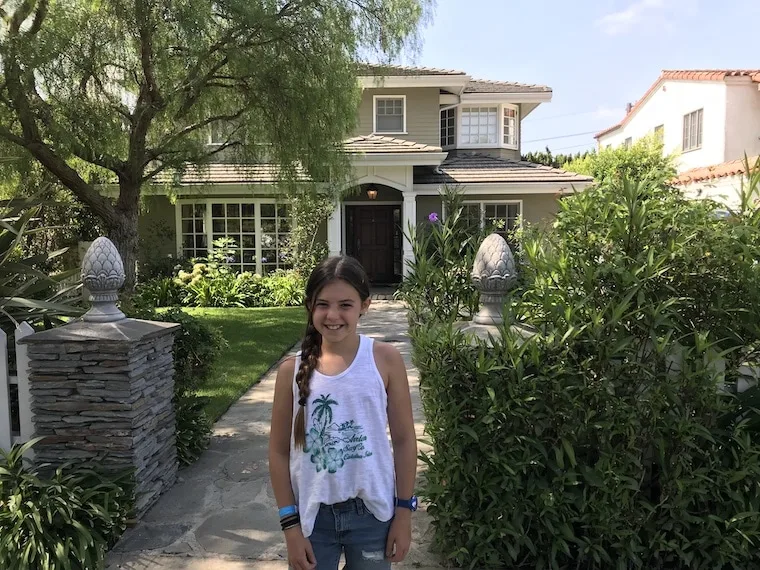 Phil and Claire's TV house from "Modern Family," young girl pictured in front