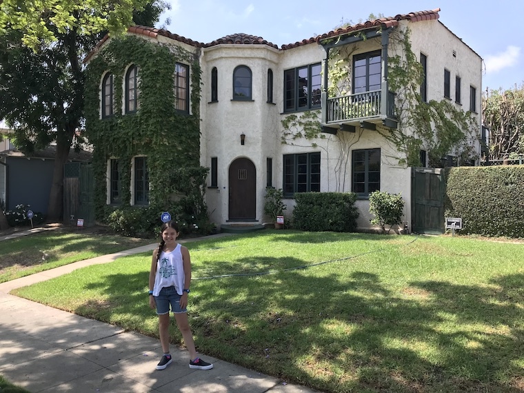 Mitch and Cam's TV house from "Modern Family," with young girl standing in front