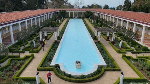 child touching the statue you're allowed to touch at the Getty Villa