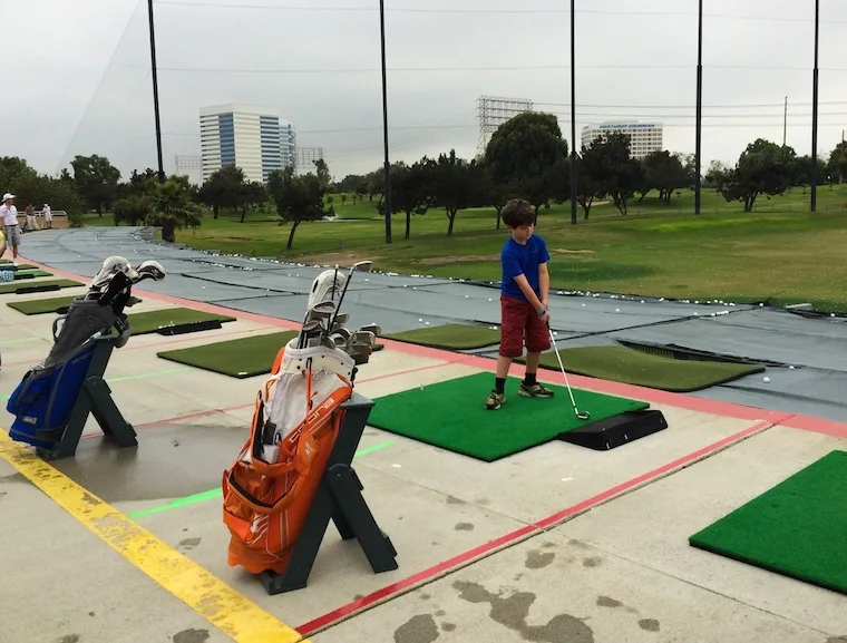 a kid swinging a golf club at the Lakes Golf course in El Segundo, California