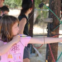 girl-doing-archery-at-sleep-away-camp-in-California
