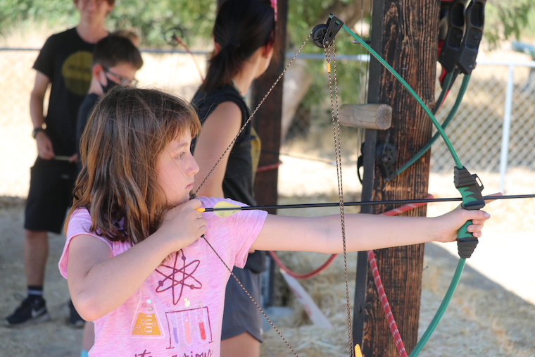 girl-doing-archery-at-sleep-away-camp-in-California