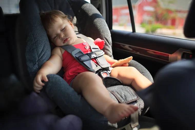 Baby girl sleeping in car seat