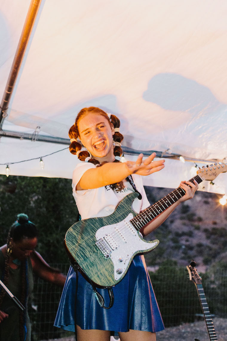 girl guitarist on stage and happy at Amplify Sleep Away Camp