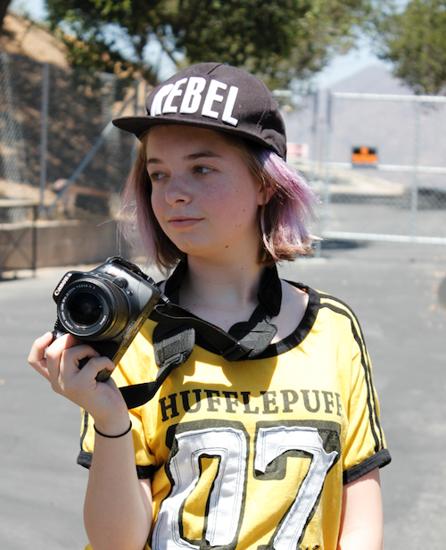 girl wearing Rebel Hufflepuff clothes with camera Amplify sleep away camp for girls