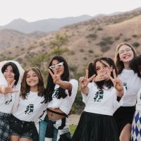 six-girls-smiling-and-making-peace-signs-Amplify-sleep-away-camp-for-girls