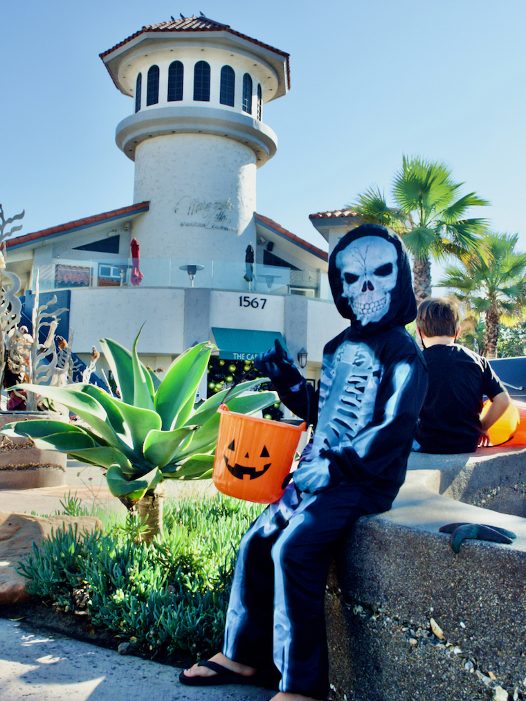 kid dressed up as a skeleton to trick or treat