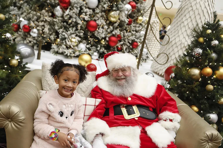 happy young girl smiling with Santa Claus