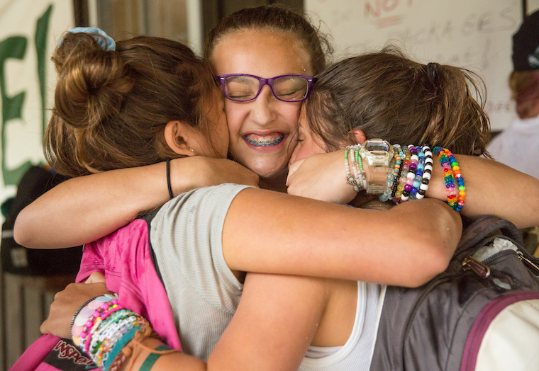 girls hugging at Summer Camp Photo courtesy of Camp Romaca in Hinsdale, MA. Reprinted by permission of the American Camp Association.