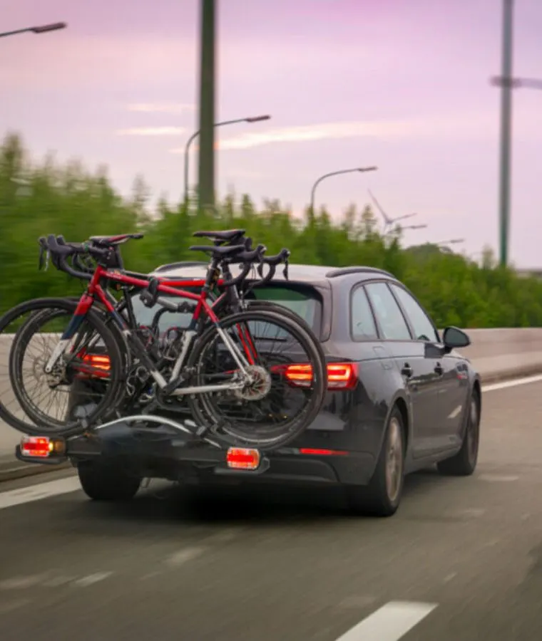 car on the highway with bikes on the back