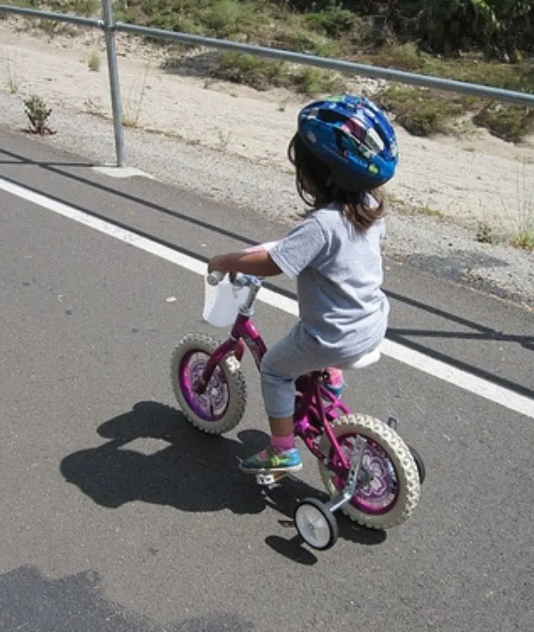 young child riding a bike on the bike path