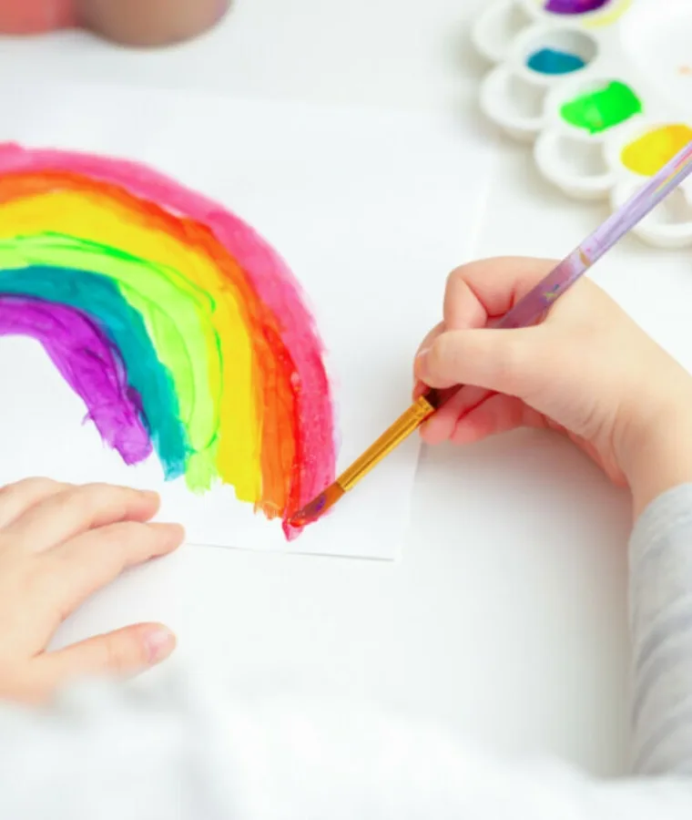 child painting a rainbow