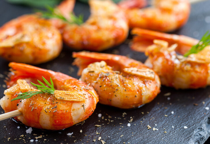 Shrimp tails grilled on wood skewer featured image