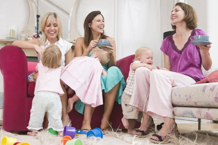 3 moms laughing and having fun with their babies