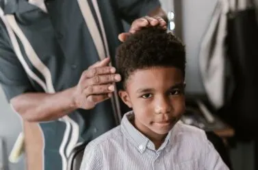 African American child getting haircut