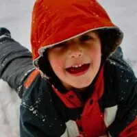 kid playing in snow