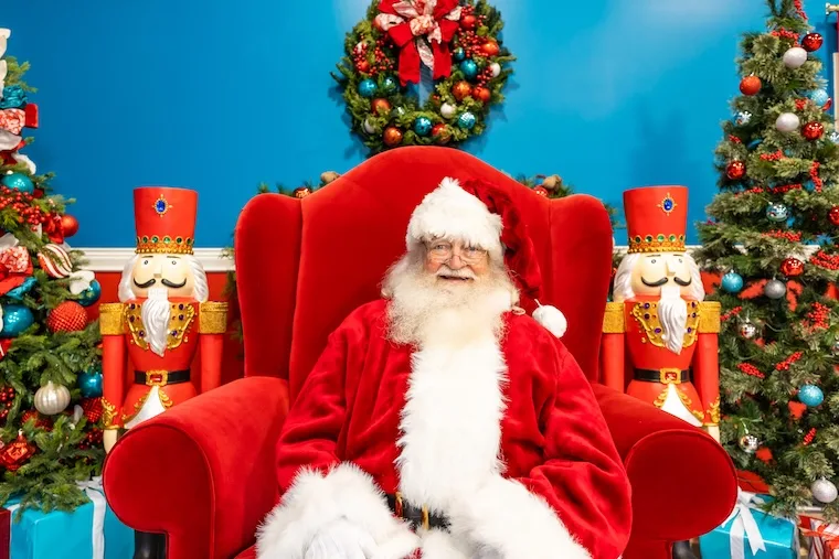 Santa in a red chair at the Collection at River Park 