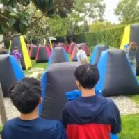 kids playing laser tag seeing over their shoulders
