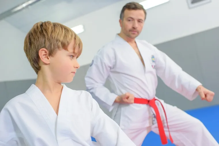 Young boy in a martial arts lesson with instructor