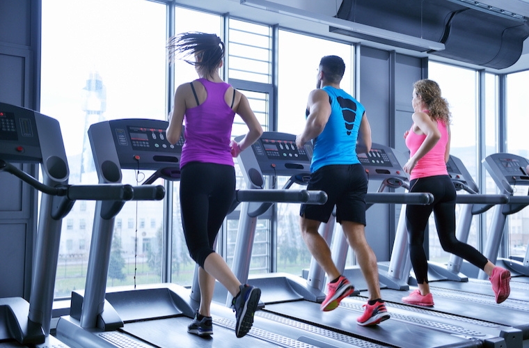 Group of people running on treadmills