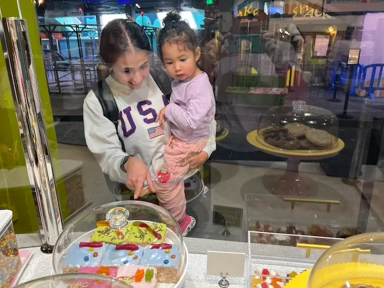 mom and toddler looking at sweet spot goodies
