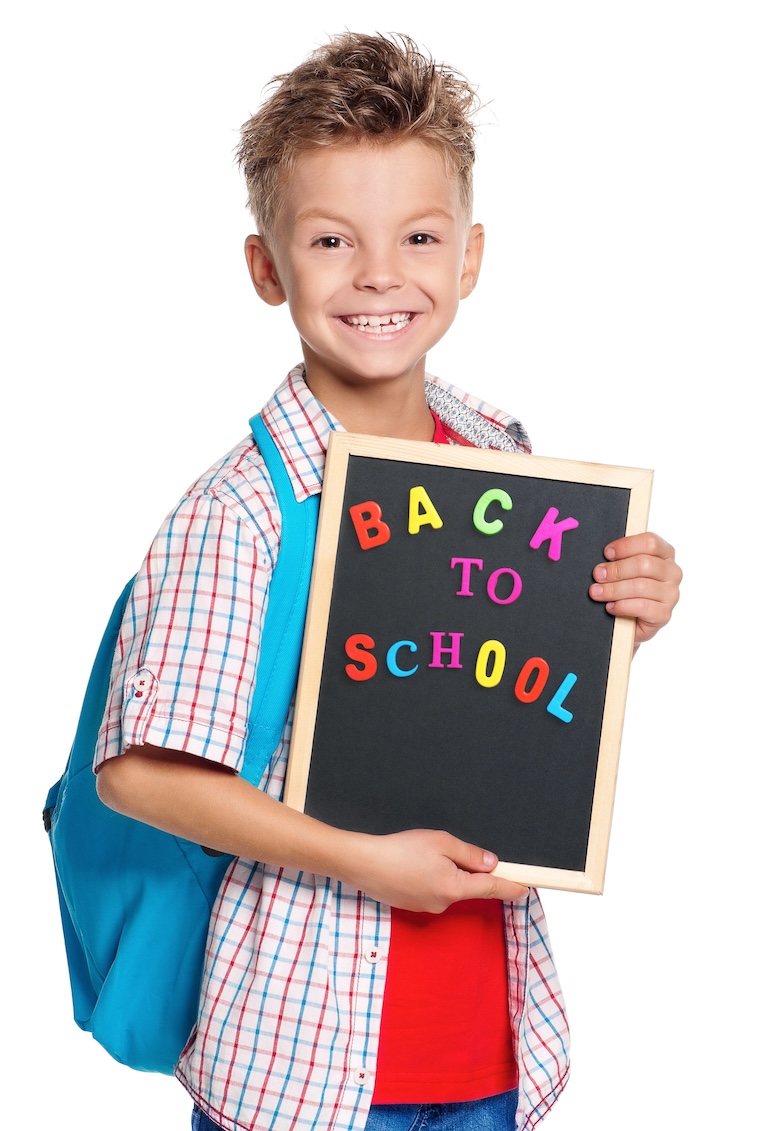 boy with back to school sign