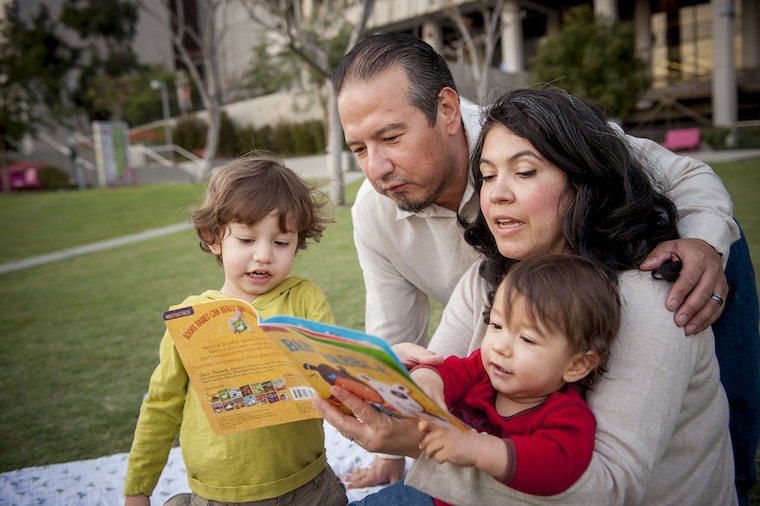 Family reading together outside First 5 LA